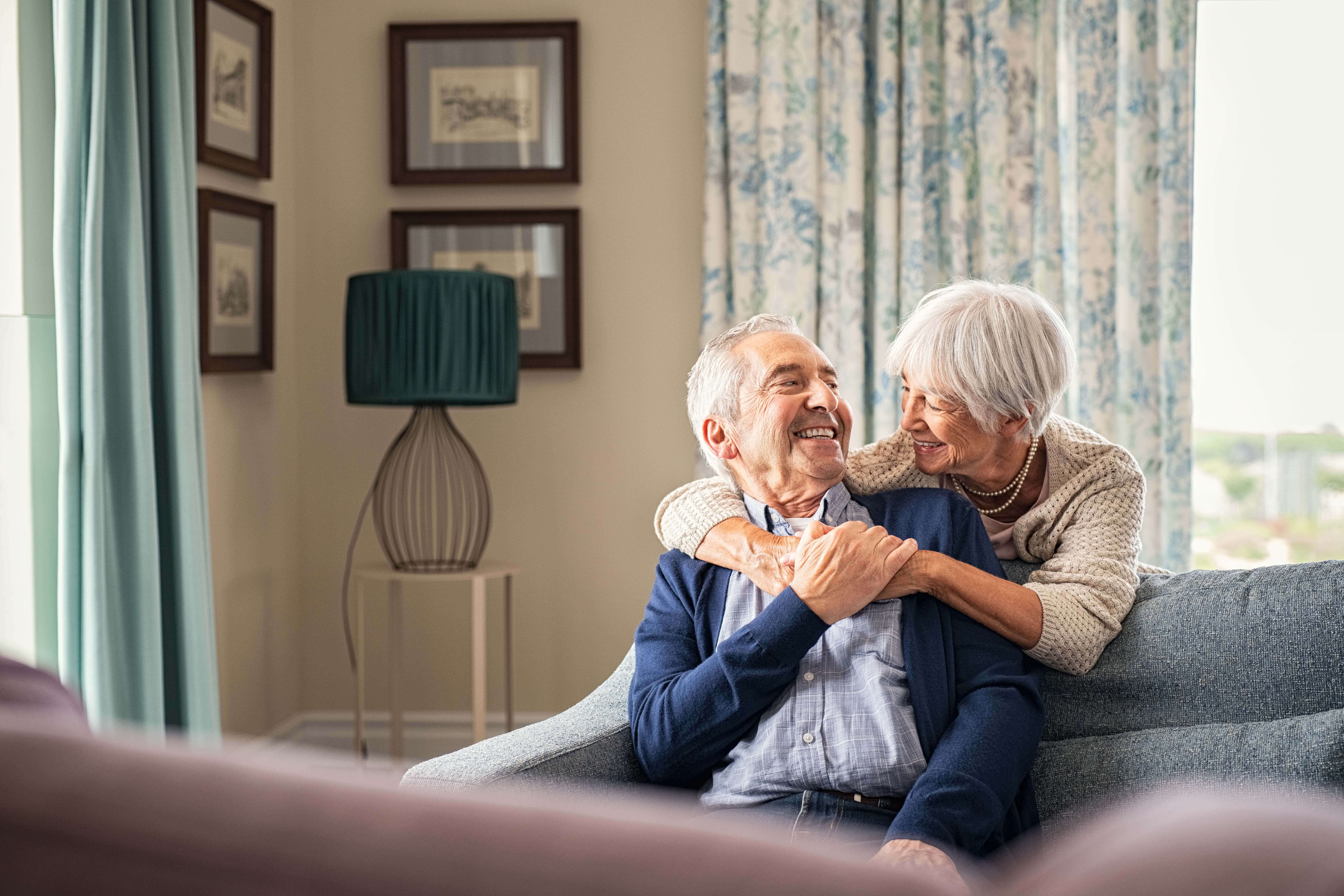 Senior couple at home, smiling together — the freedom Liftology installs deliver