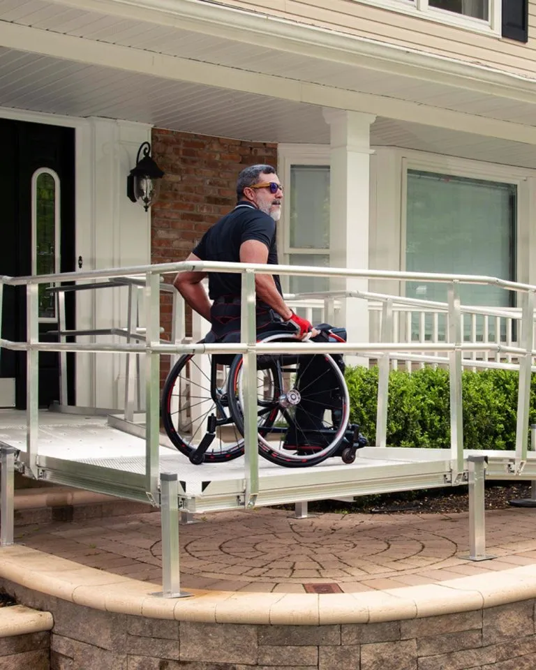 Man in wheelchair on a National Ramp wheelchair ramp